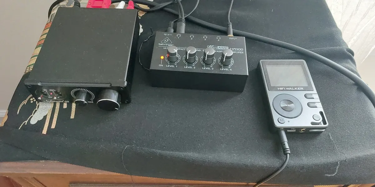 Audio equipment with a mixer and a microphone on a table.